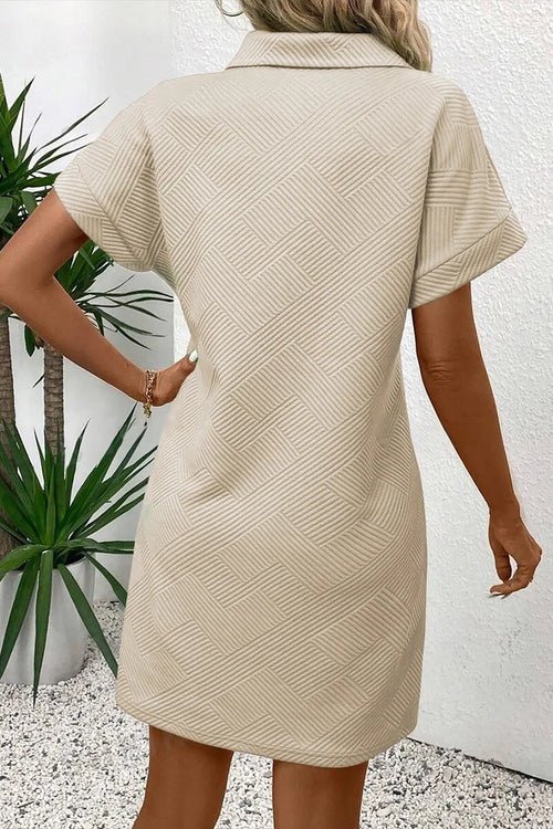 Beige button-front short-sleeve mini dress from back, pointed collar and sleeves.