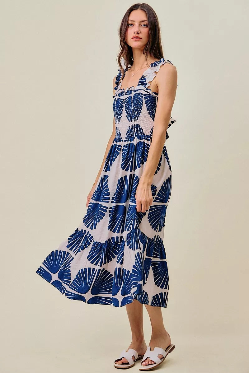 Full length view of navy and white abstract print smocked bodice tiered midi dress