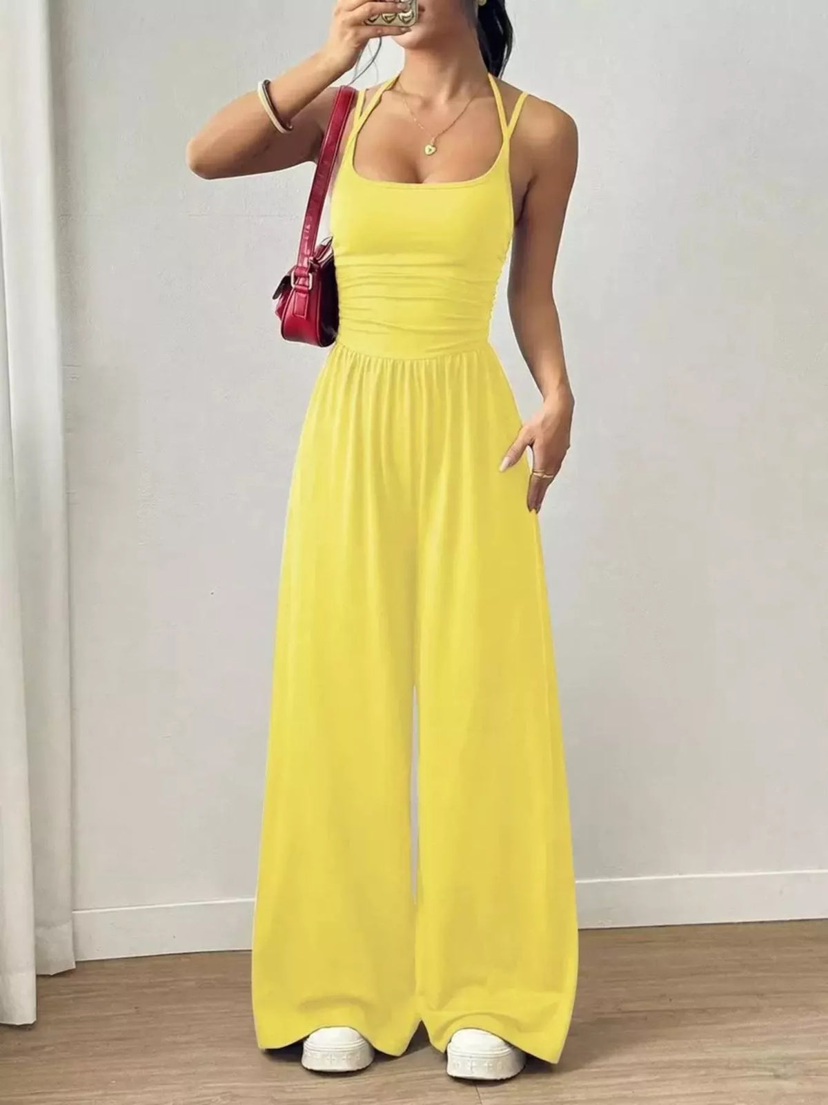 Yellow spaghetti strap wide-leg jumpsuit with smocked waist and floor-length wide legs