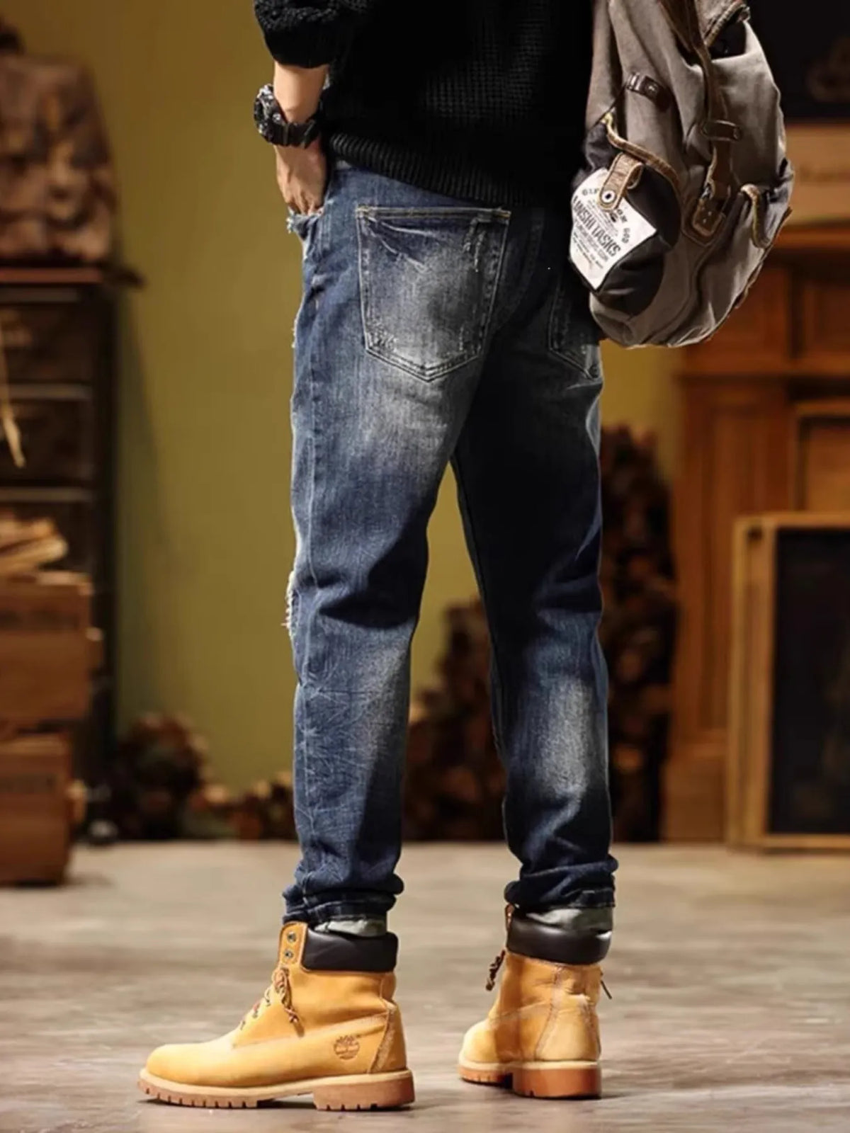 Men's blue slim-fit distressed jeans with back pocket and scattered rips