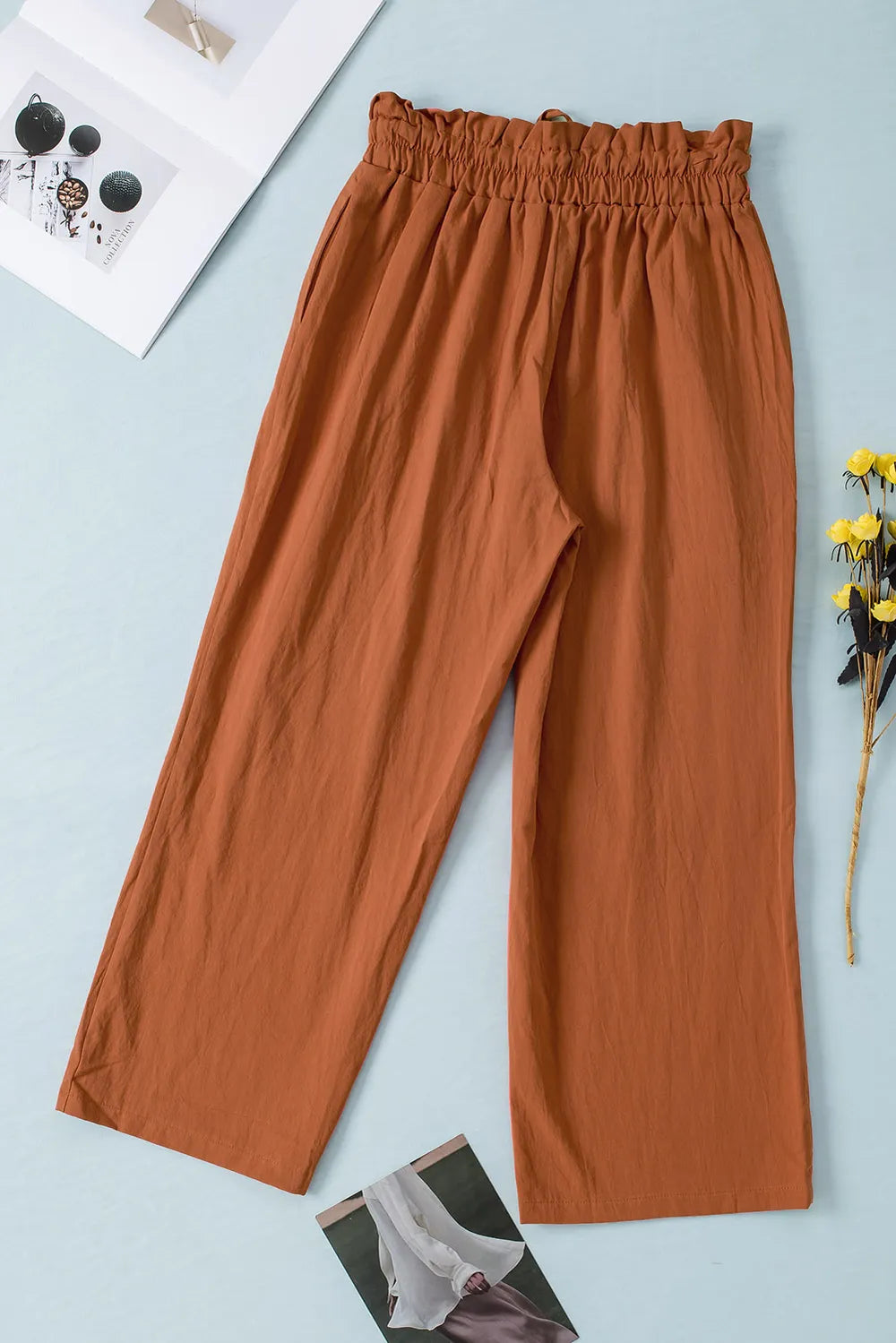 Terracotta paperbag waist wide-leg pants with gathered waistband and roomy straight legs.