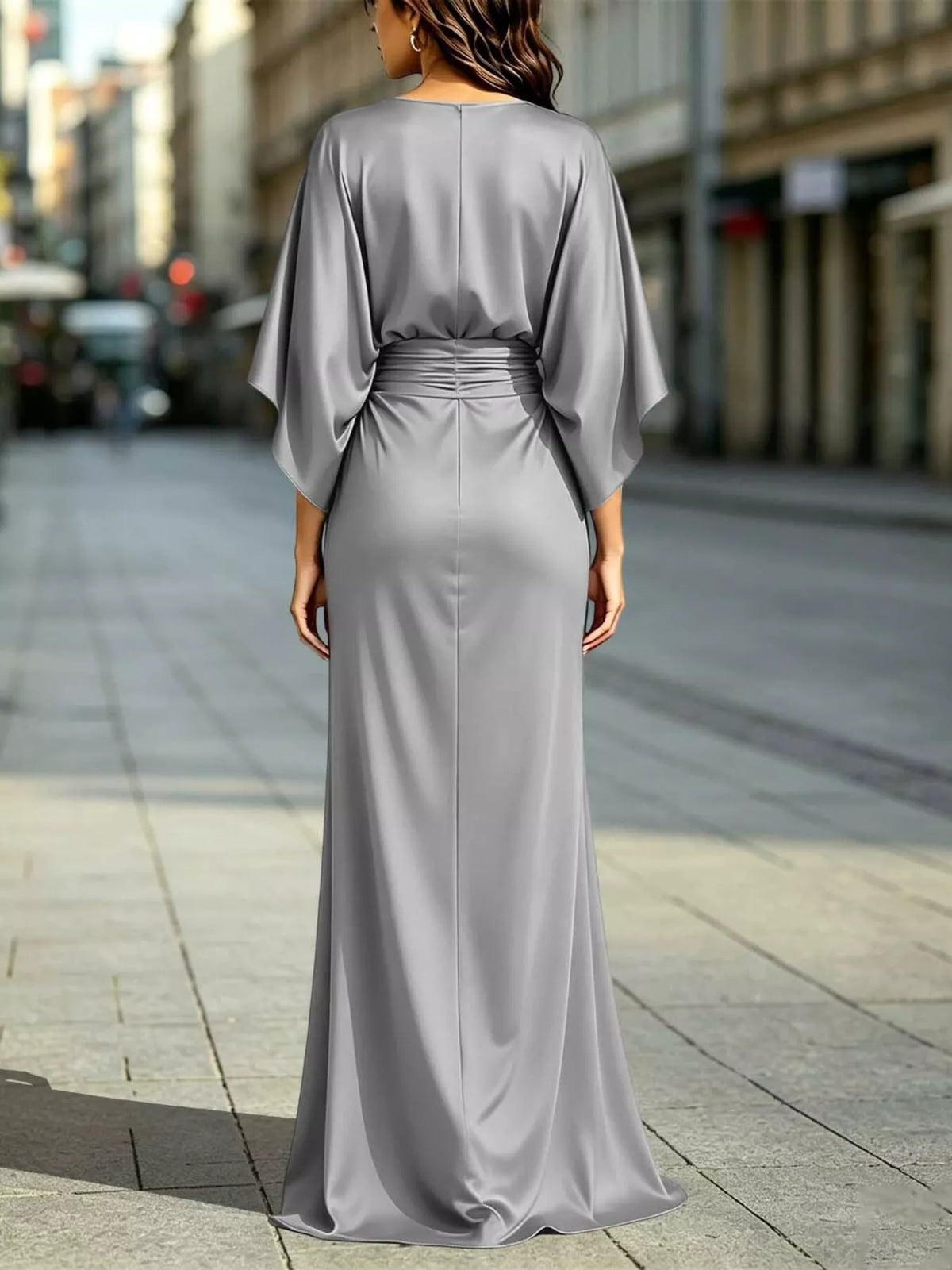 Back view of ruched waist maxi dress with draped dolman sleeves and front slit in light silver-gray