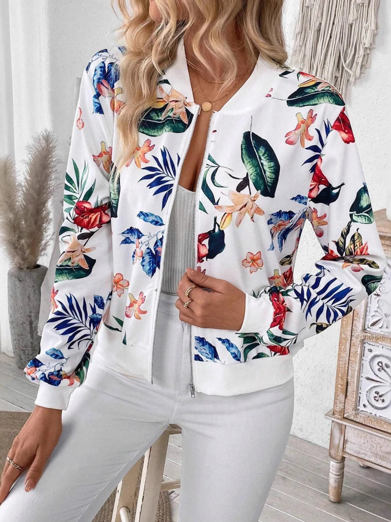 Floral zip-up long-sleeve jacket with white center zip and colorful tropical print