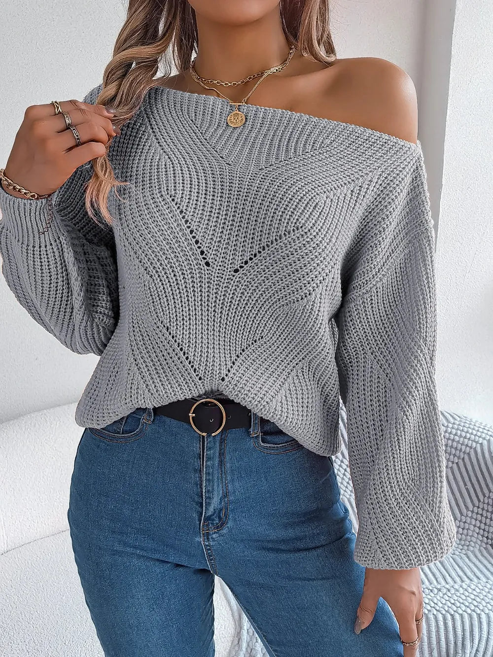 Gray openwork long sleeve sweater with off-shoulder neckline and ribbed cuffs, button front.