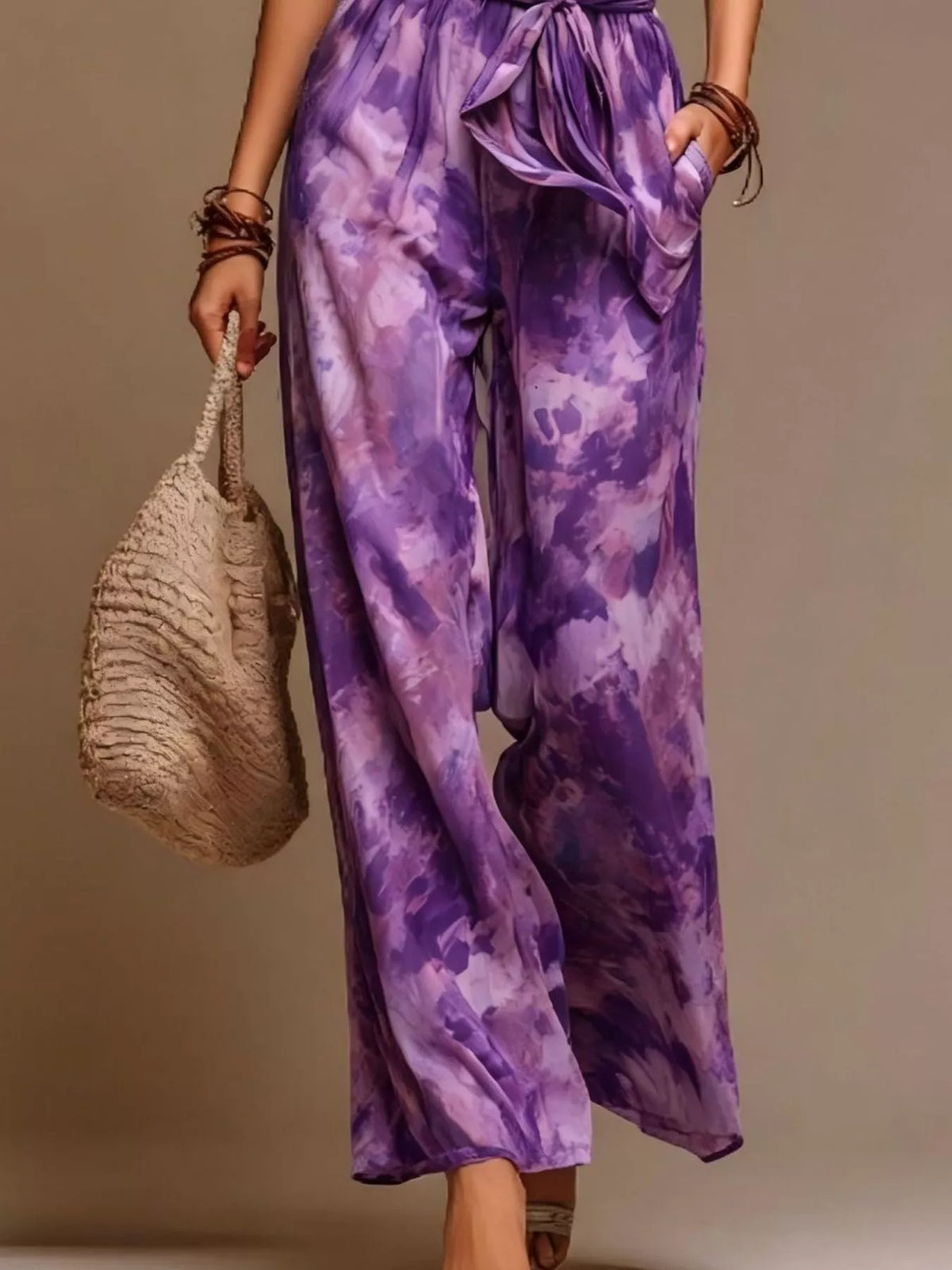 Purple tie-dye halter wide-leg jumpsuit with tied waist belt and flowy pant legs