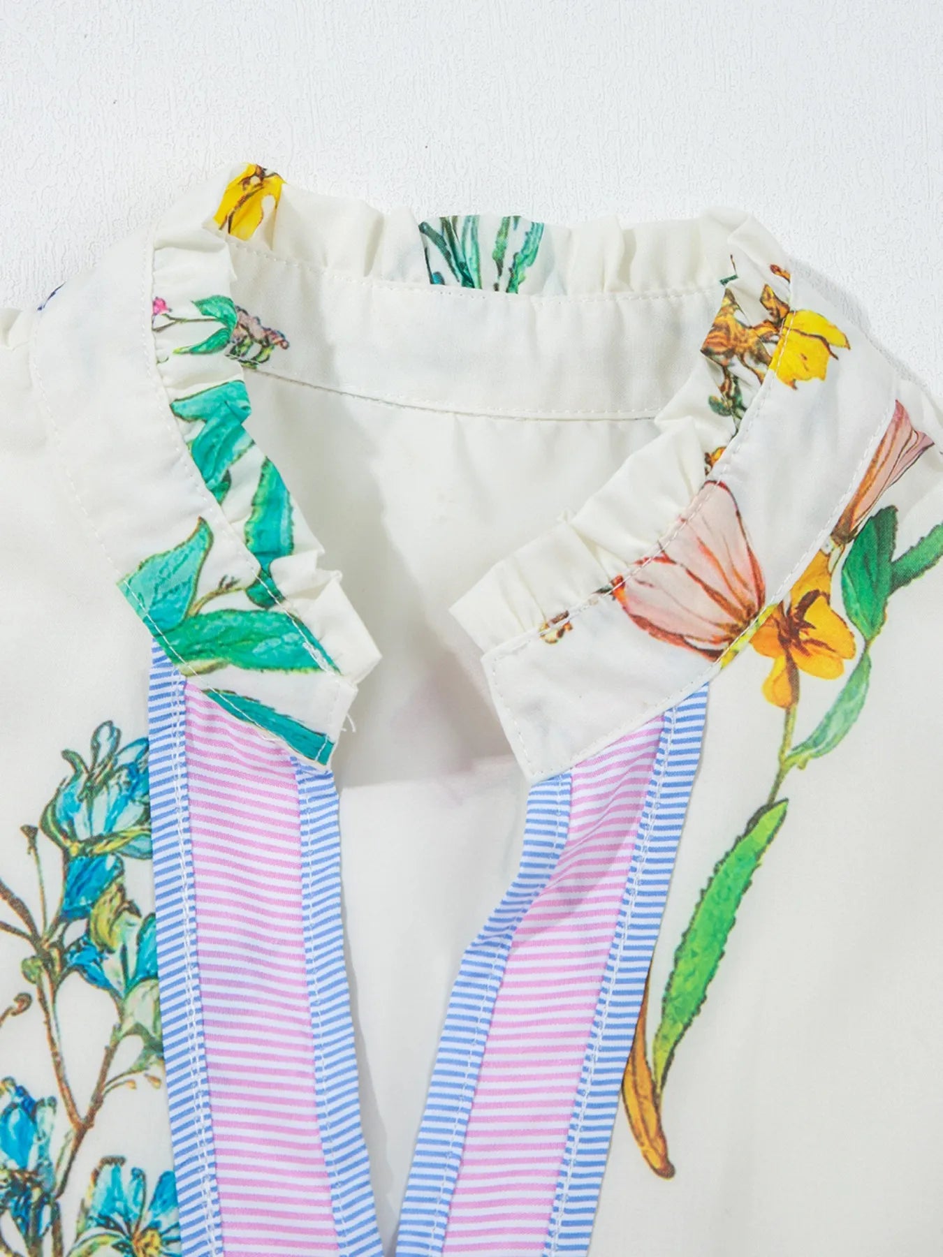 Floral Print Notched Short Sleeve Dress on white fabric with ruffle neckline and pink-blue striped straps