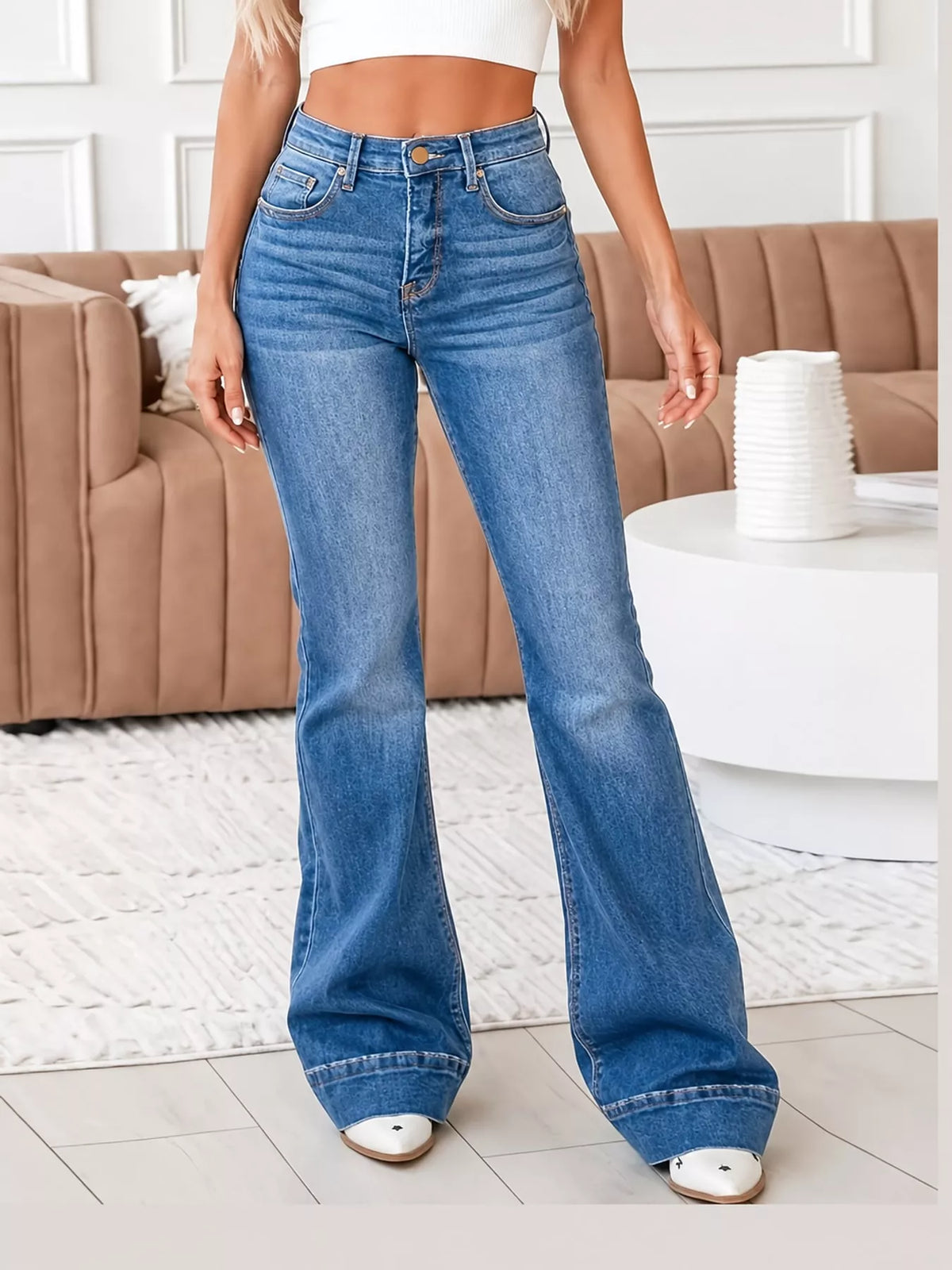 High-rise washed flare-leg jeans in light-to-medium blue with front pockets and zip fly
