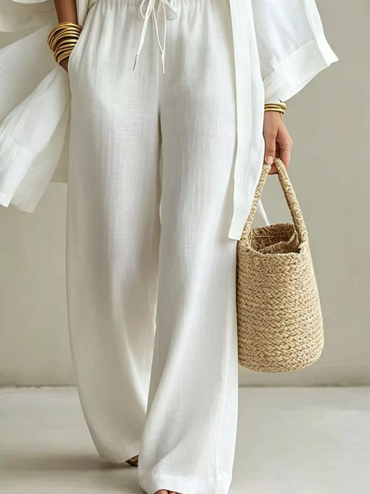 White wide-leg pants with drawstring waist and open cardigan, side view detail