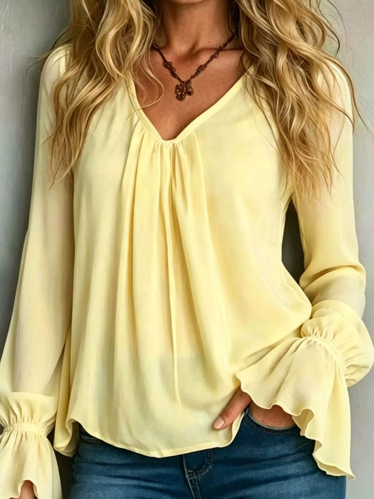 Women’s v-neck polyester blouse in pastel yellow with flounce sleeves and gathered neckline