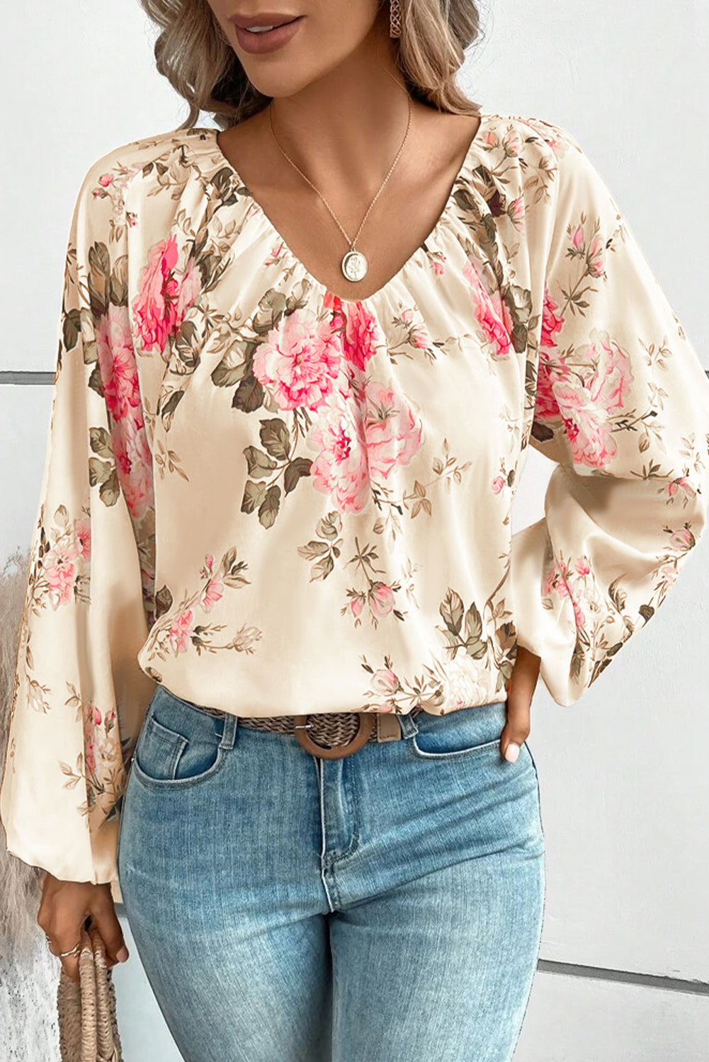 Beige floral V-neck blouse with gathered neckline and long balloon sleeves