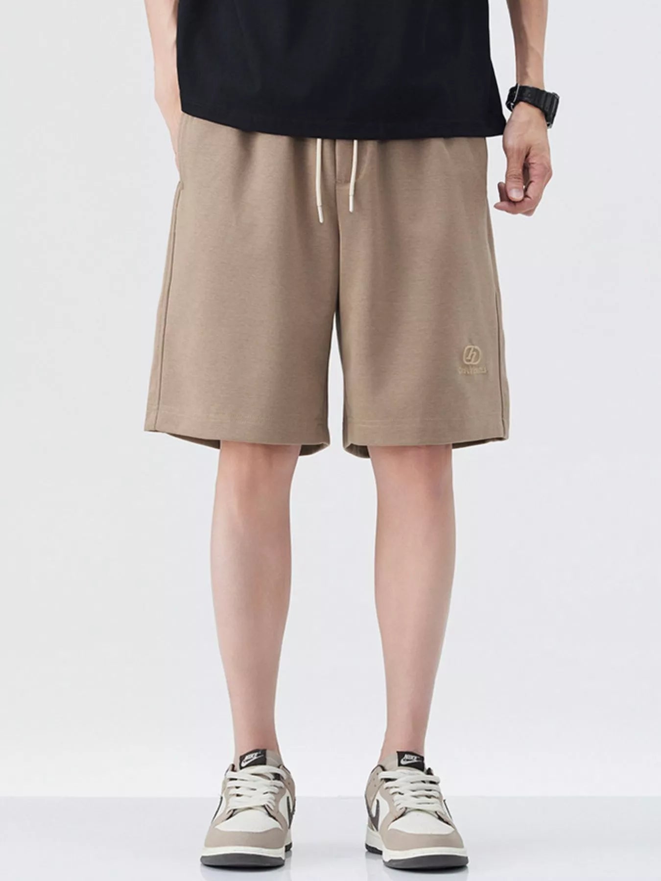 Khaki drawstring loose-fit shorts with side logo and relaxed knee-length cut