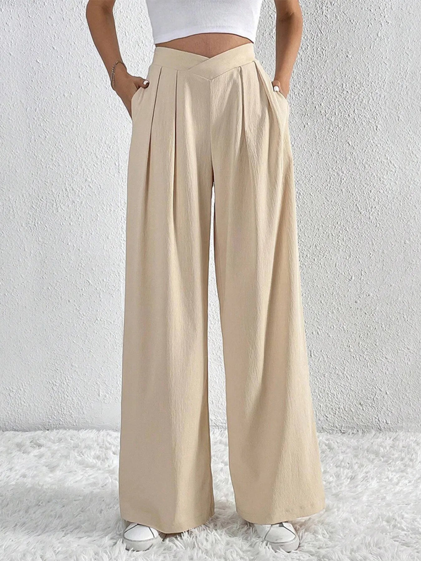 Beige wide-leg pants with ruched front and V-waist detail