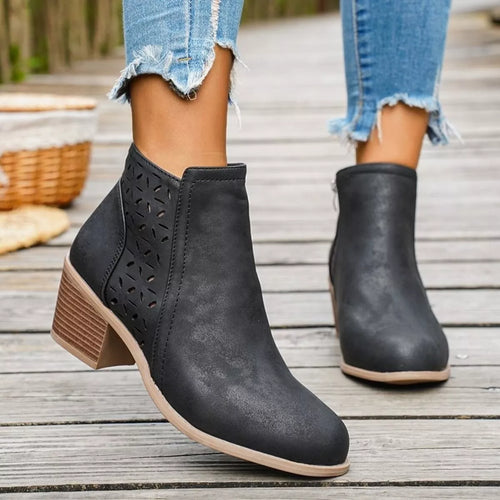 Black ankle boots with block heel, side cutout panels, and pull-on style.