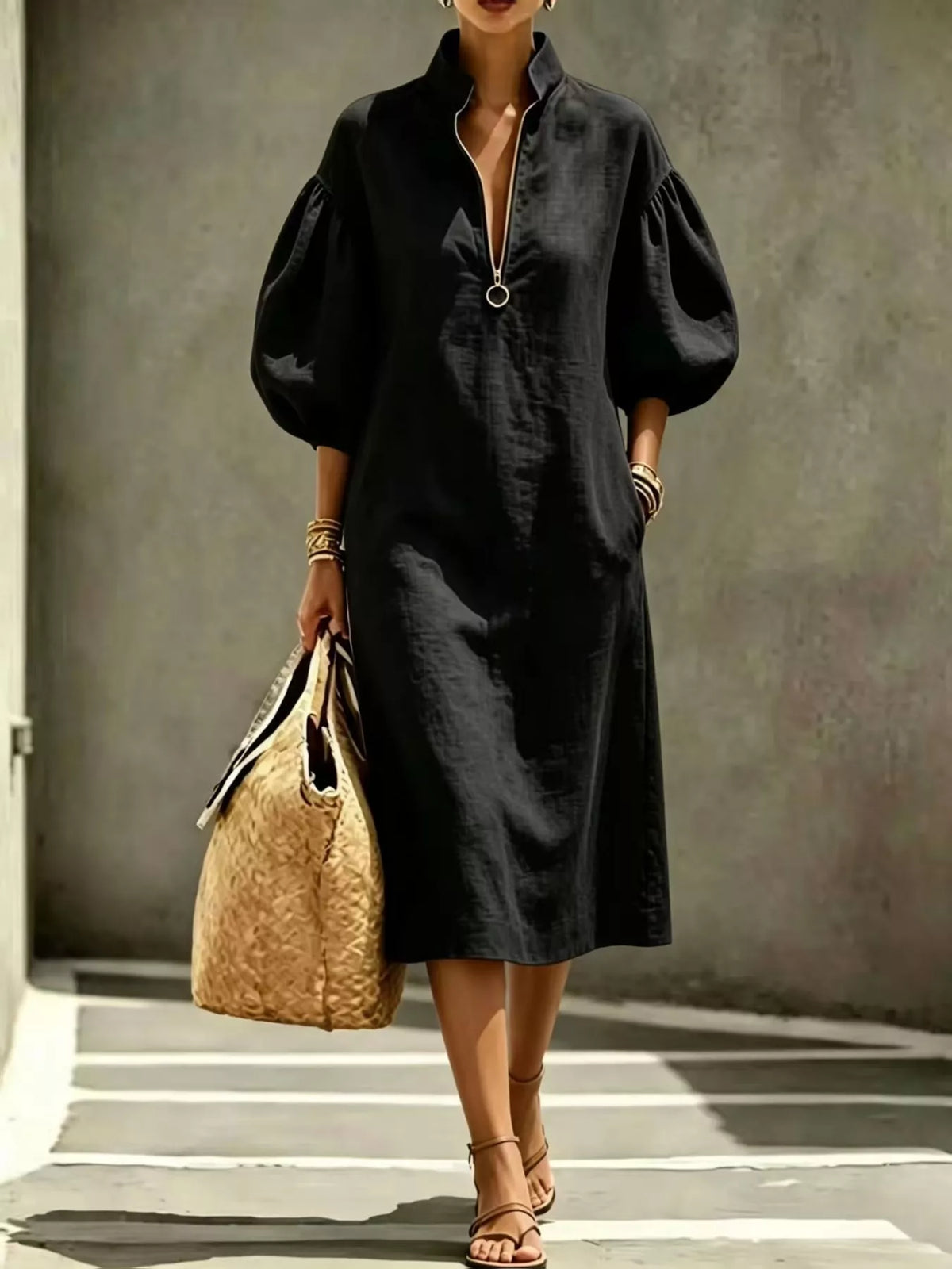Black relaxed midi dress with half-zip and puff sleeves, front three-quarter view
