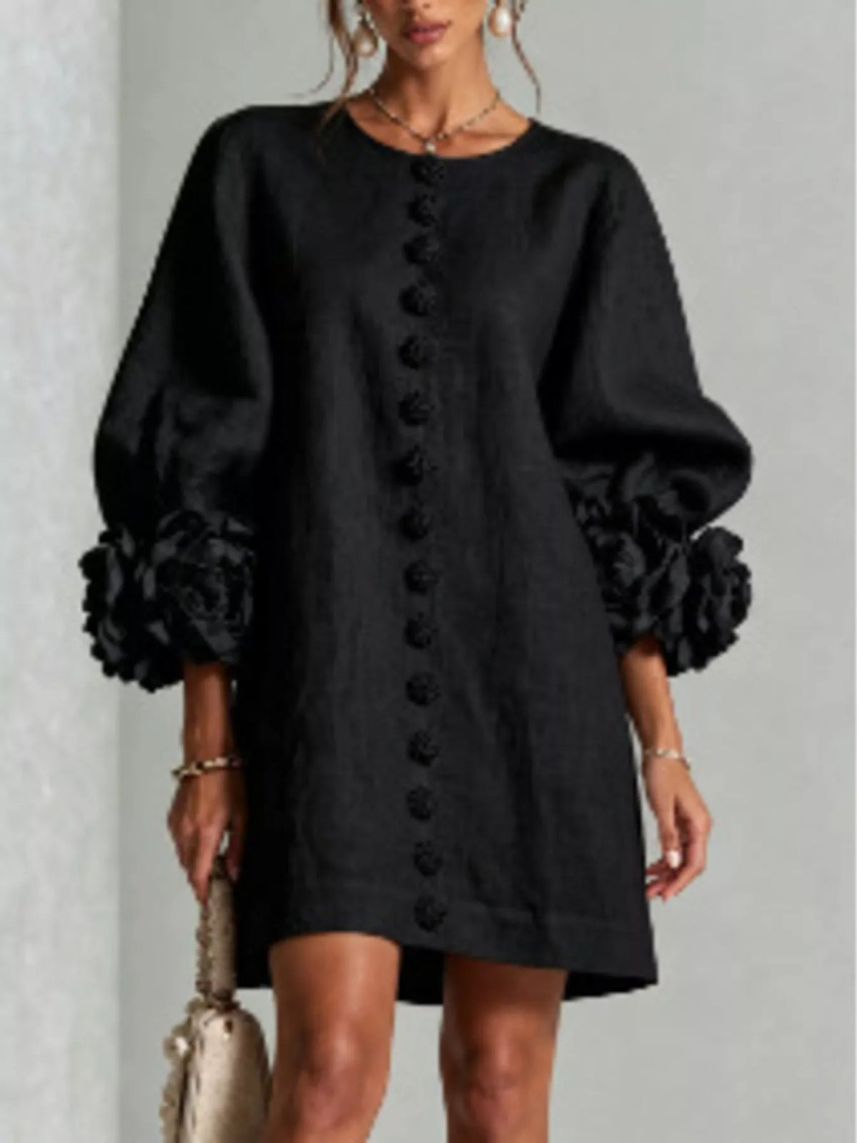 Black round-neck polyester dress with long sleeves, floral cuff details, and vertical buttons