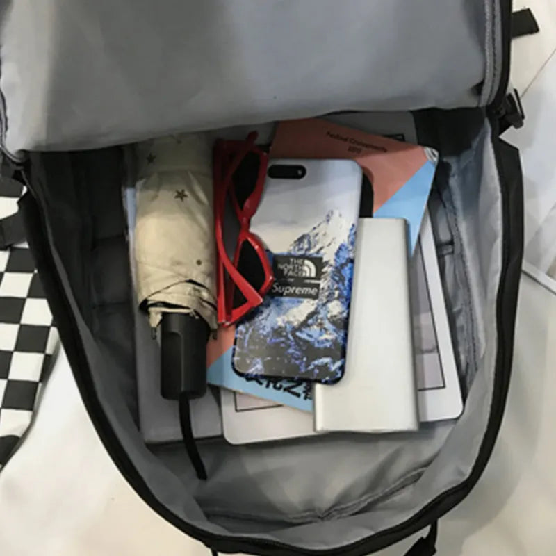 Black backpack open interior with organizer panel and small items stored inside