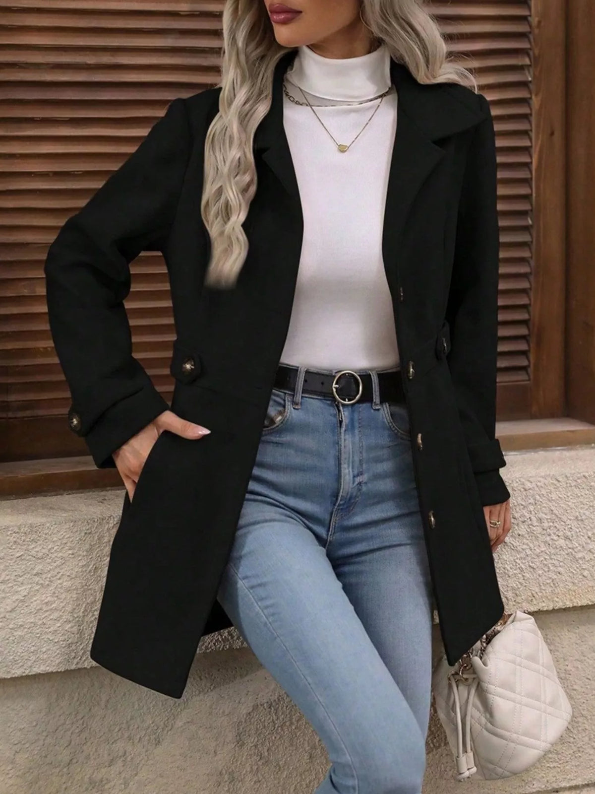 Black long-sleeve single-breasted coat with notched lapel and button front