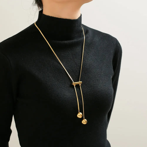 Gold-plated beaded necklace with two parallel strands and hollow ball charms