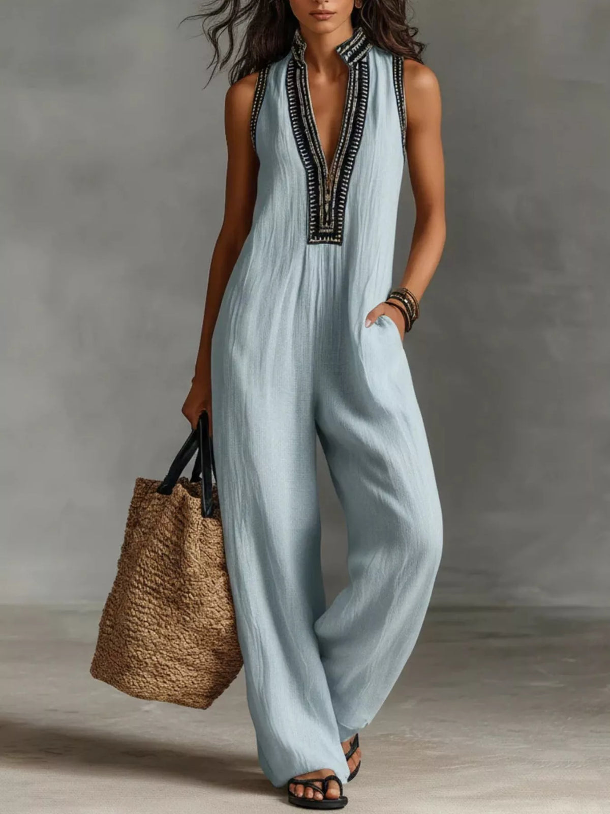 Light blue sleeveless wide-leg jumpsuit with V-neck embroidery and side pockets