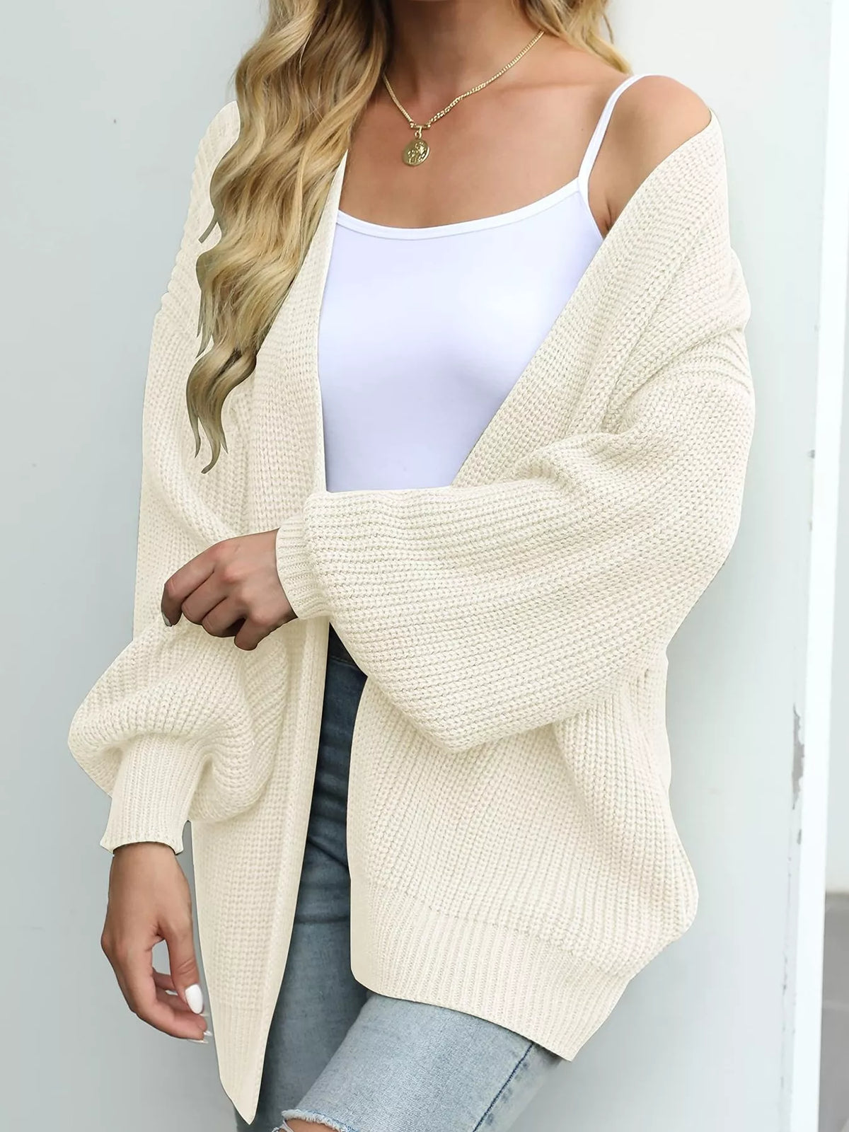 Cream/white waffle-knit open-front chunky cardigan with long sleeves and draped front.