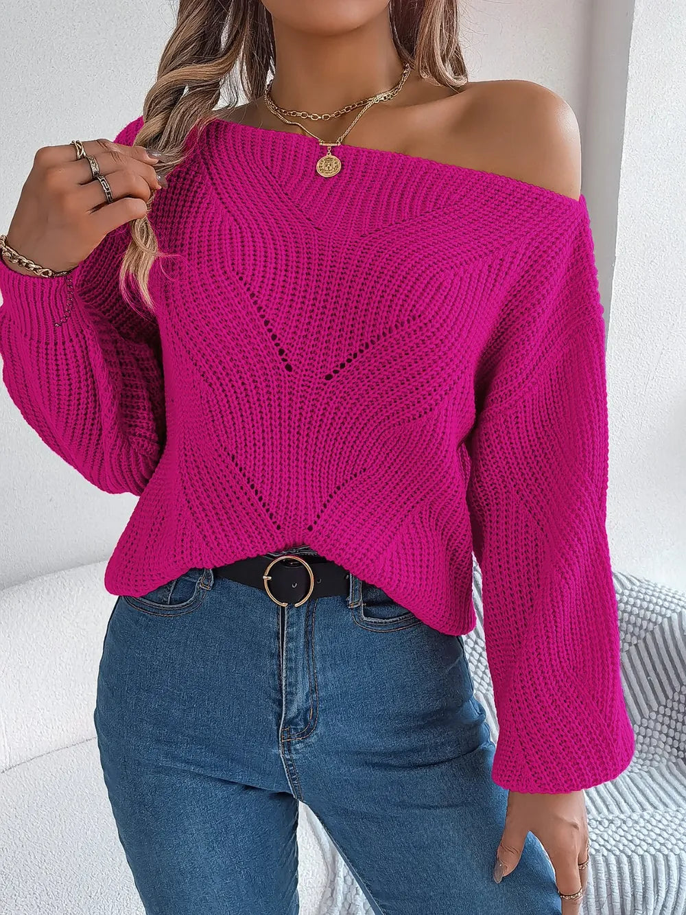 Cerise pink openwork long sleeve sweater with off-shoulder neckline, textured V knit, button front.