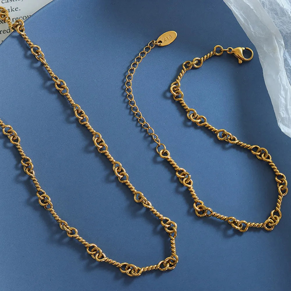Gold chain bracelets laid flat, showing link texture and toggle clasps