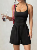 Black sleeveless ruched spaghetti strap romper with gathered waist and shorts