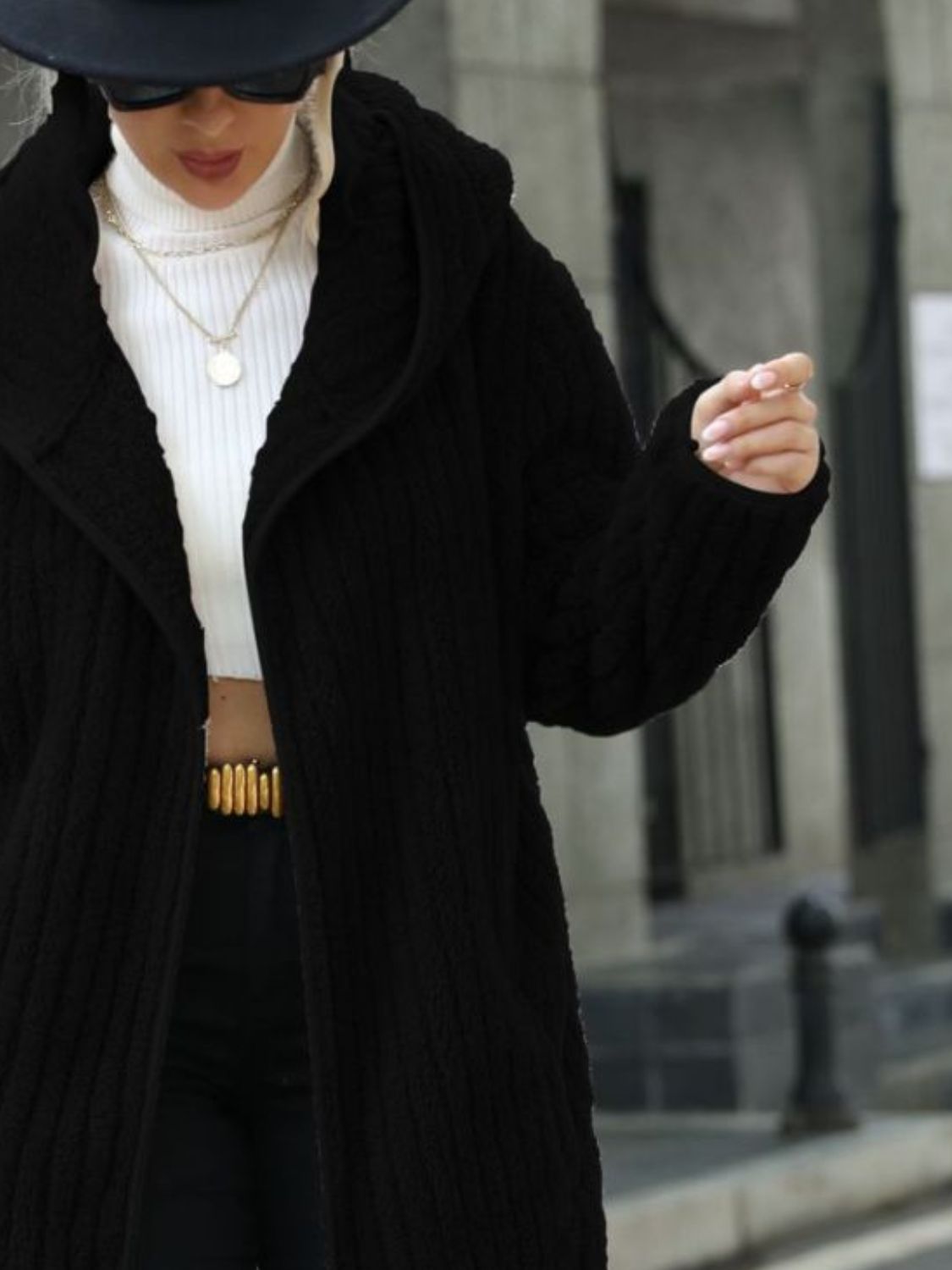 Black ribbed hooded open-front coat detail with hood and vertical ribbing texture