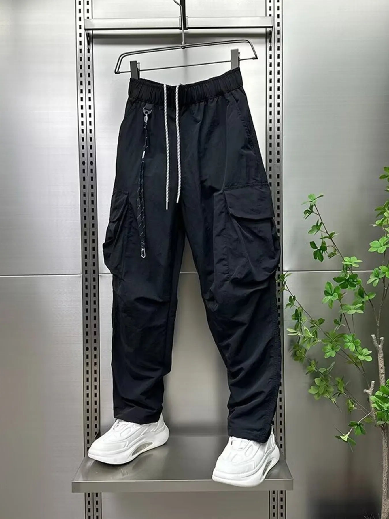 Men's plus size drawstring cargo pants, wide-leg, black with drawstring and cargo flaps.