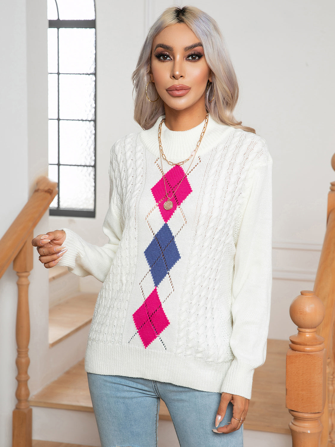 White openwork sweater with geometric diamond pattern at center and mock neck
