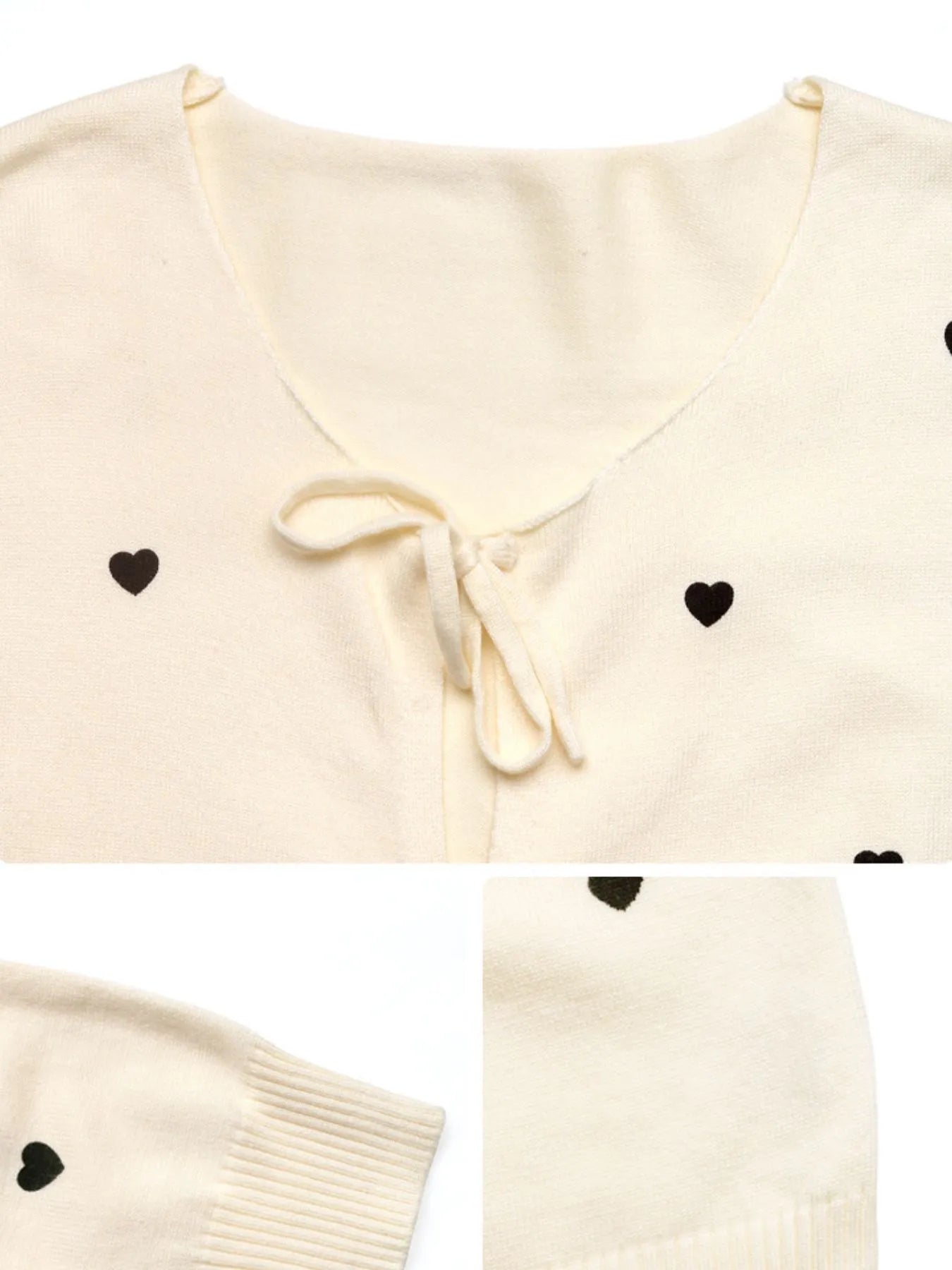 Cream cardigan close-up with heart print and tie-front bow at V-neck