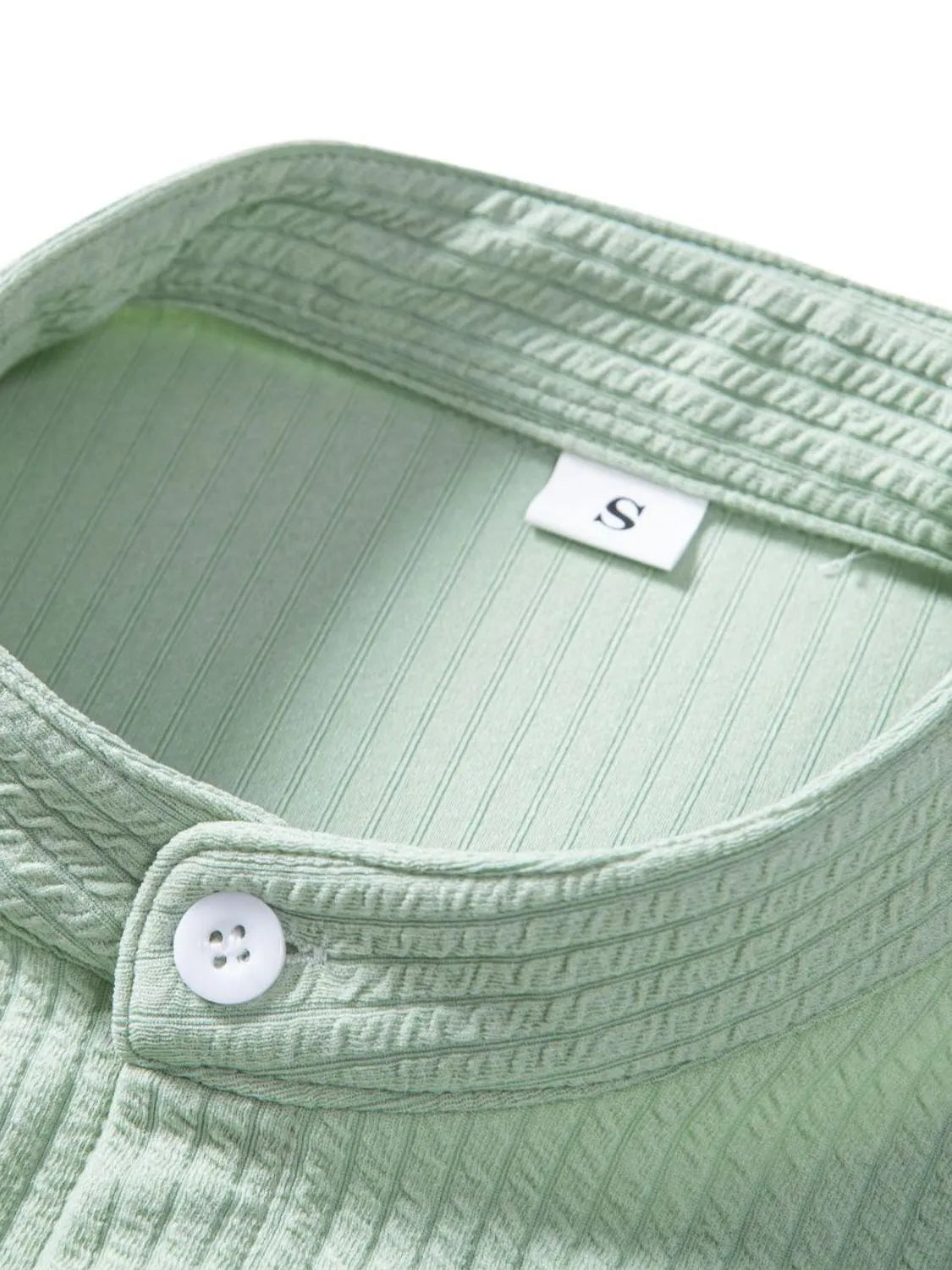 Mint green ribbed shirt neckline with button and inner label