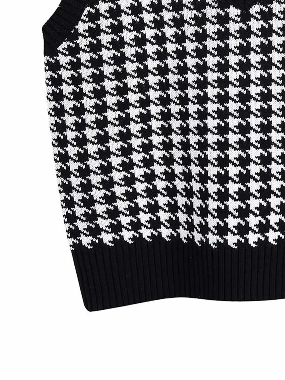Black and white houndstooth sleeveless sweater vest with ribbed lower hem