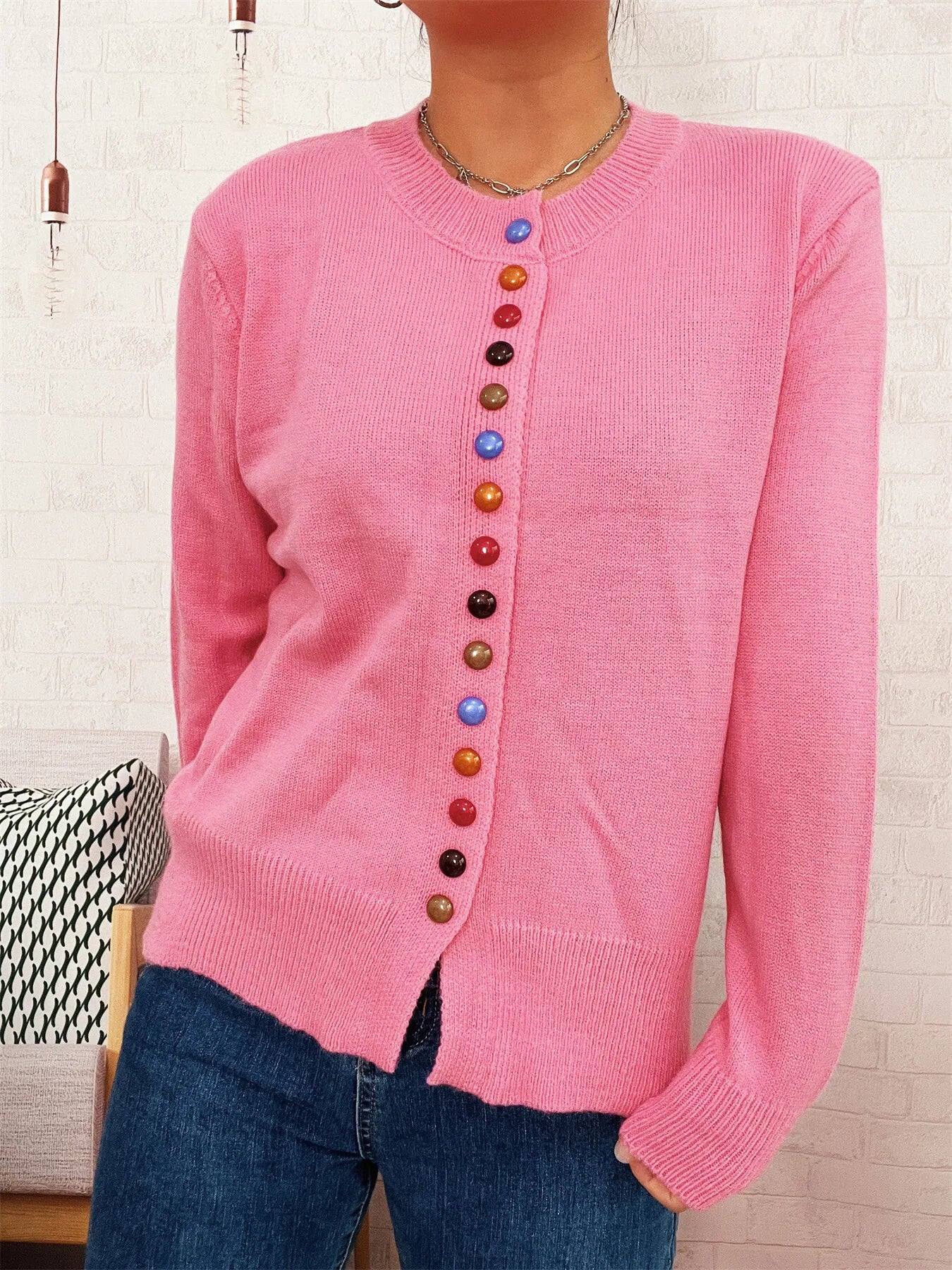 Pink button-front cardigan with crew neck, ribbed cuffs, and multicolor buttons