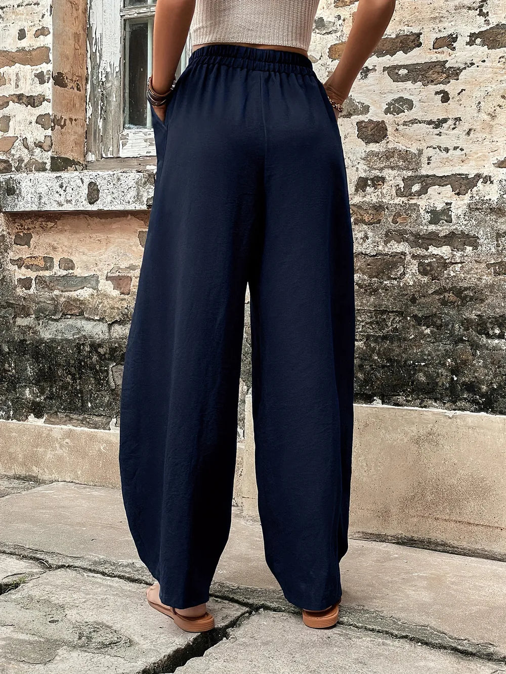 Dark blue elastic-waist pants with wide legs and gathered waistband