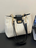 Beige woven straw shoulder bag with black trim, gold chain handles, and flap clasp