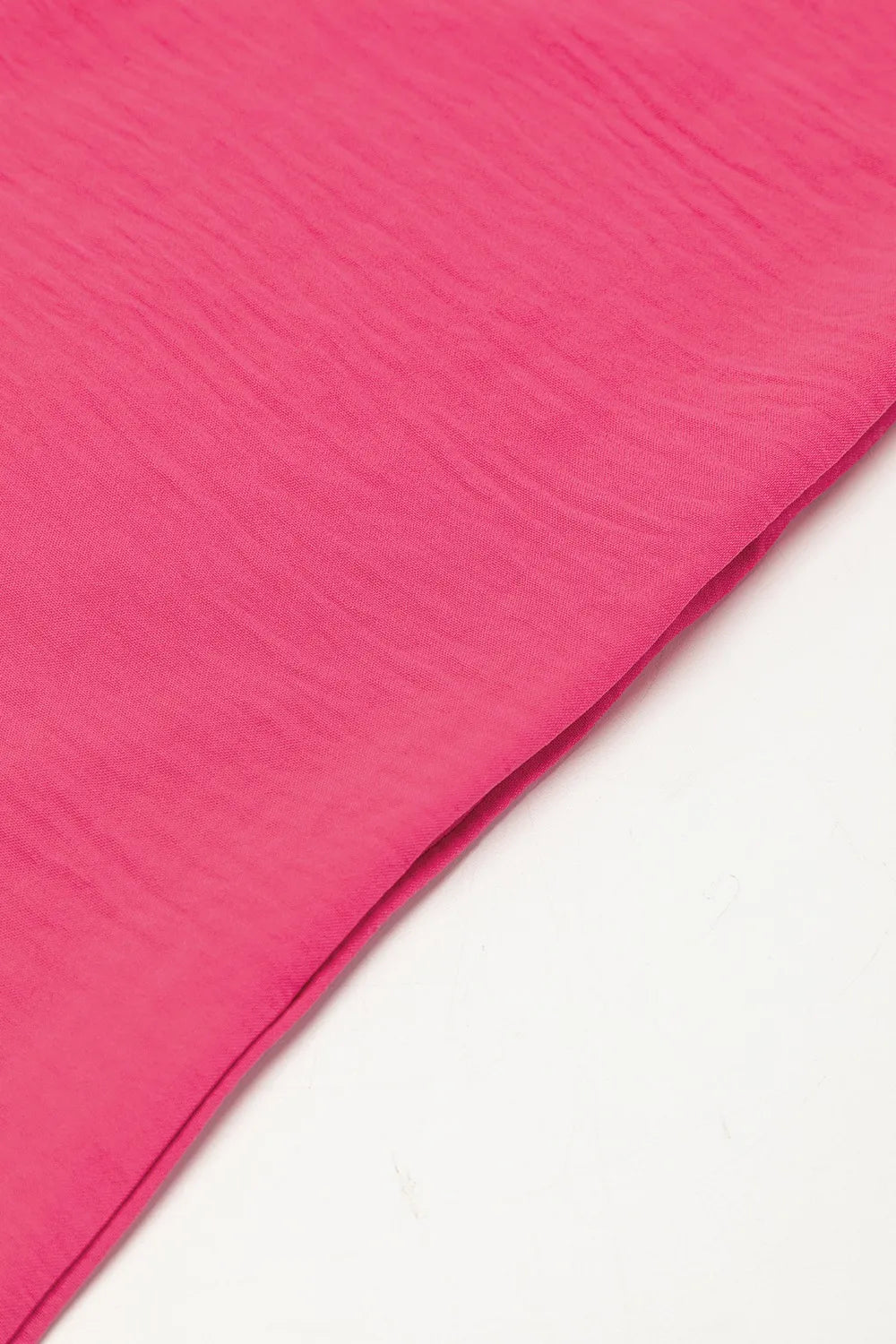 Hot pink romper fabric close-up with visible woven texture