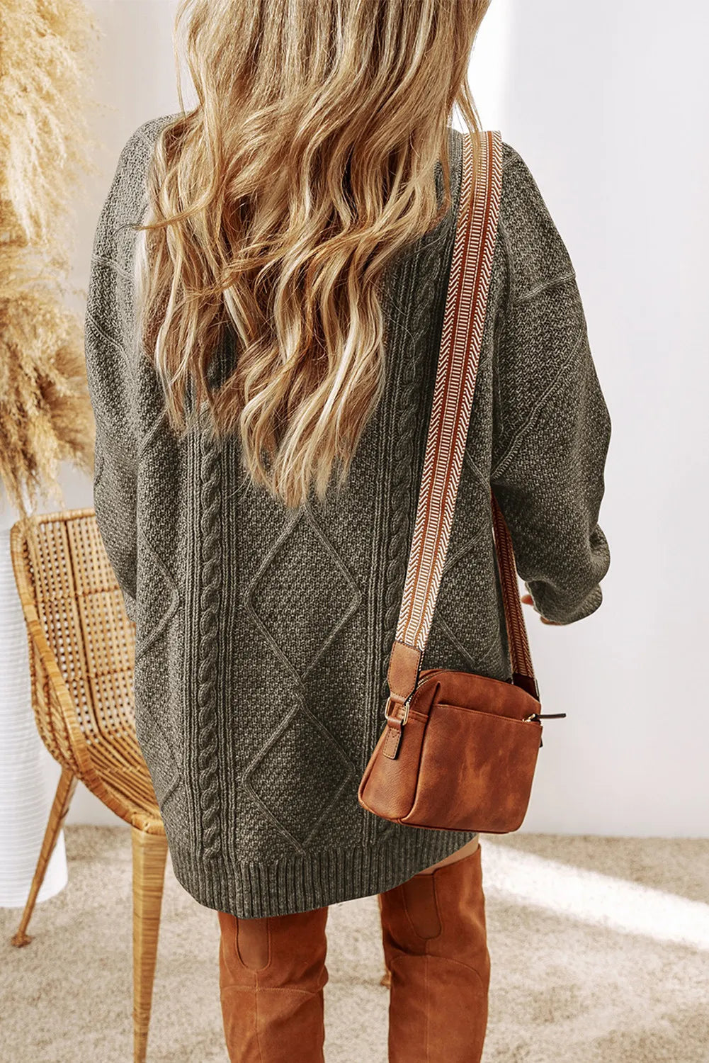 Black cable-knit round-neck sweater dress with cable pattern and long sleeves, back