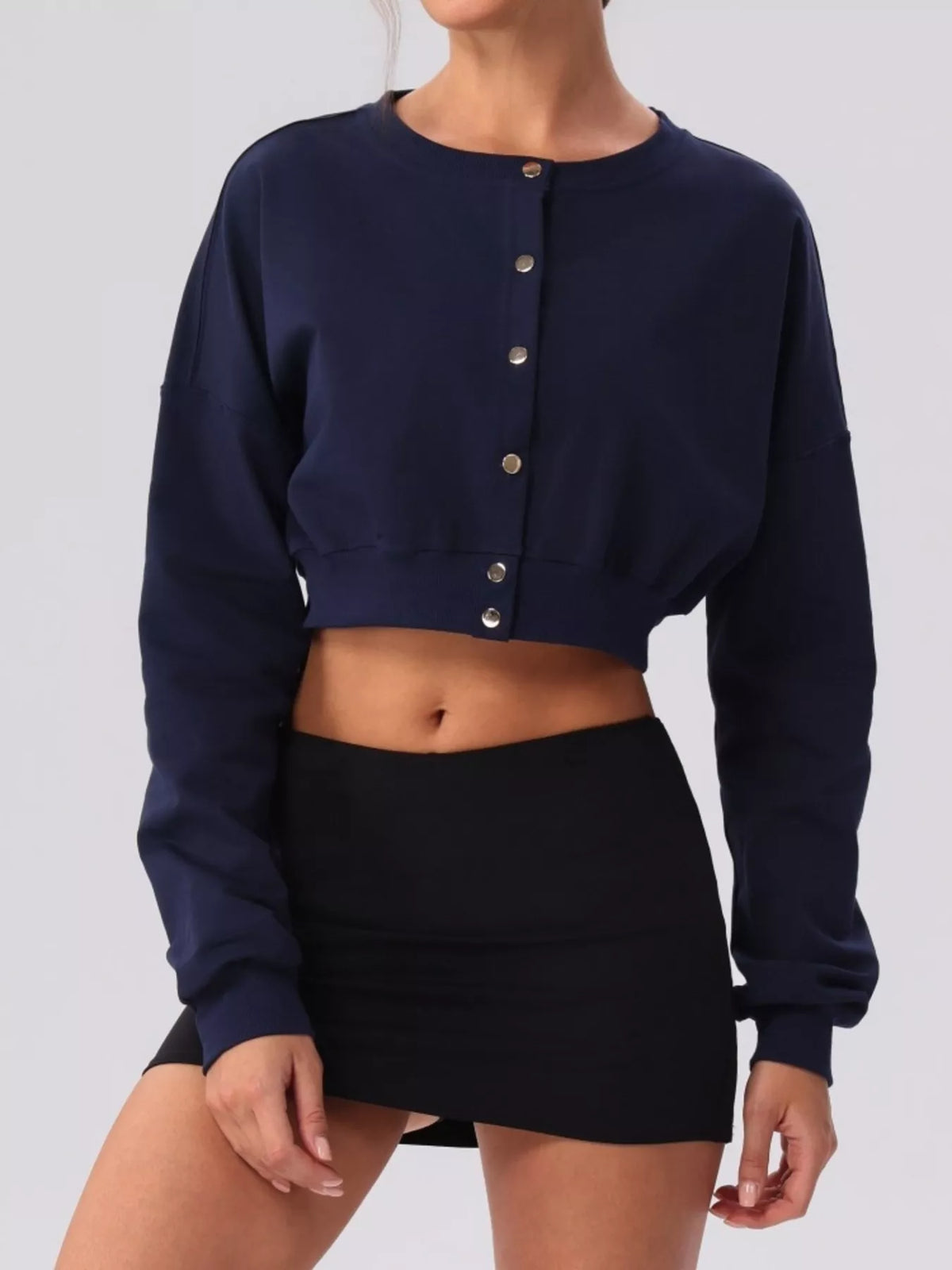 Navy blue cropped cardigan sweater with long sleeves, round neck, and button front