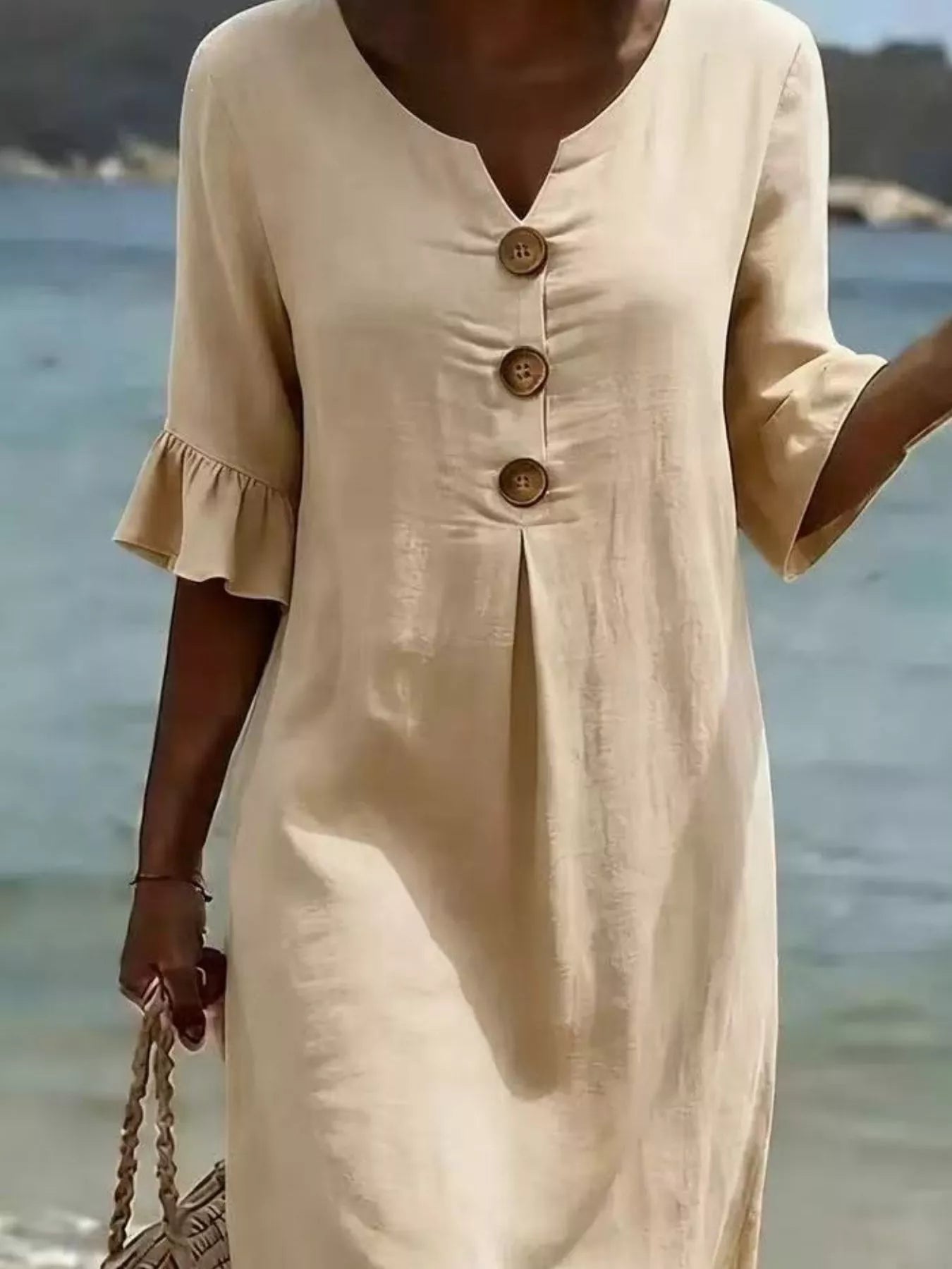 Light khaki midi dress with three round buttons and ruffled sleeve cuffs