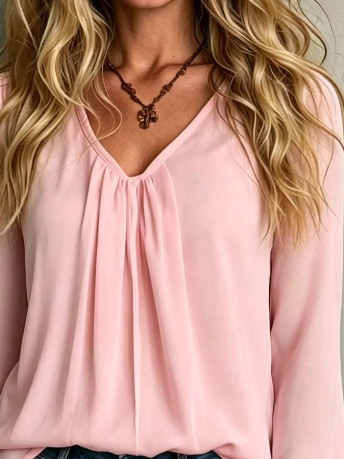 Women’s v-neck polyester blouse in dusty pink with pleated front and long flounce sleeves