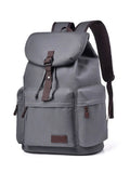 Gray canvas backpack with front flap and adjustable shoulder straps, side zip pockets