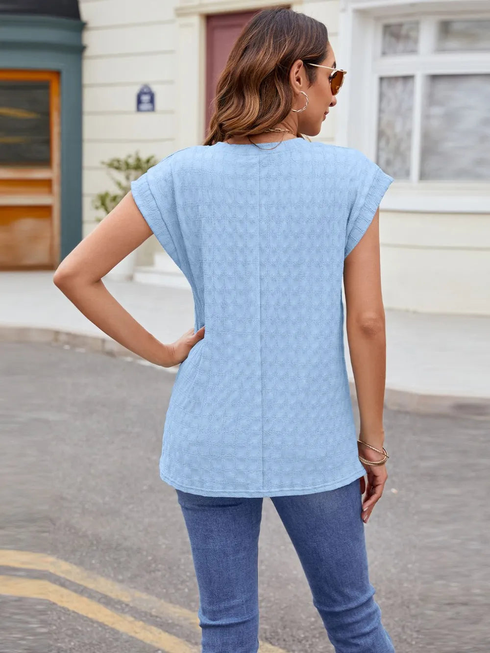 Light blue textured round-neck cap-sleeve T-shirt, back view
