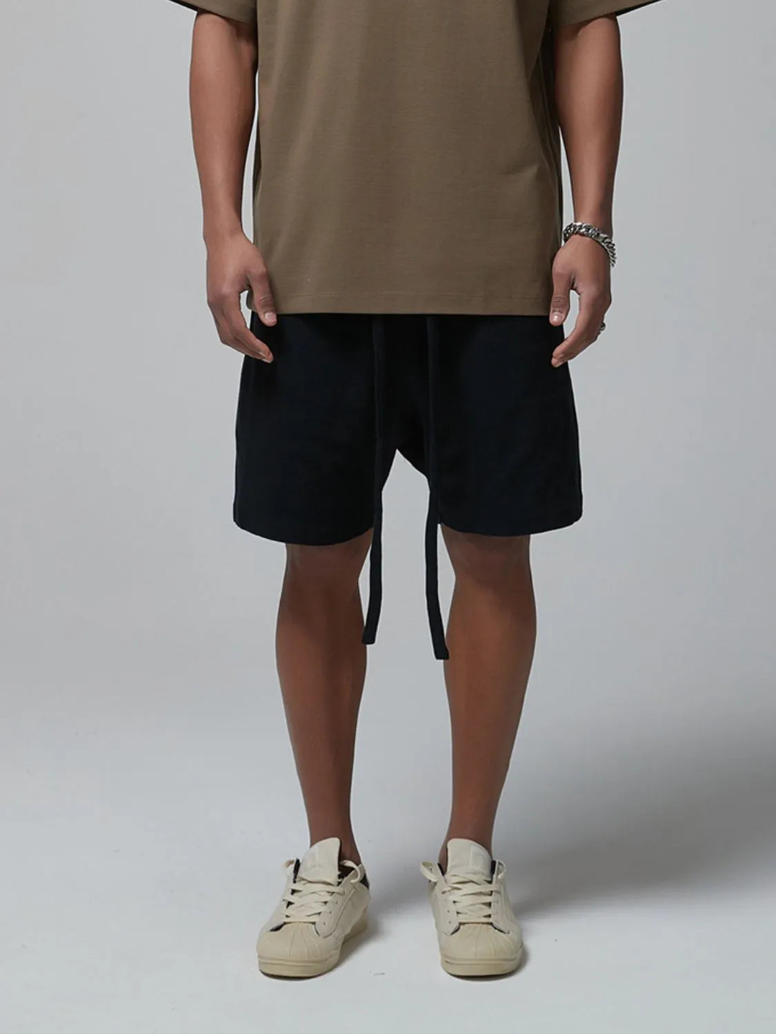 Men's dark waffle shorts with drawstring tie and side pockets, knee-length