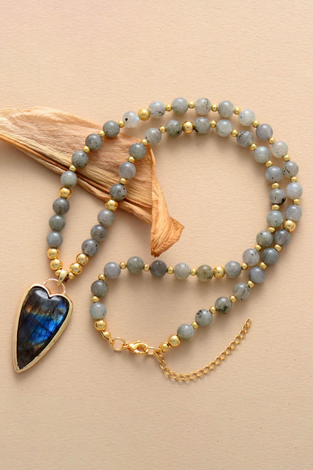 Blue-gray beaded necklace with teardrop labradorite-style stone pendant and gold beads