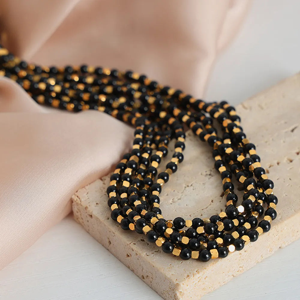 Agate beaded necklace with layered black and gold-tone bead rows