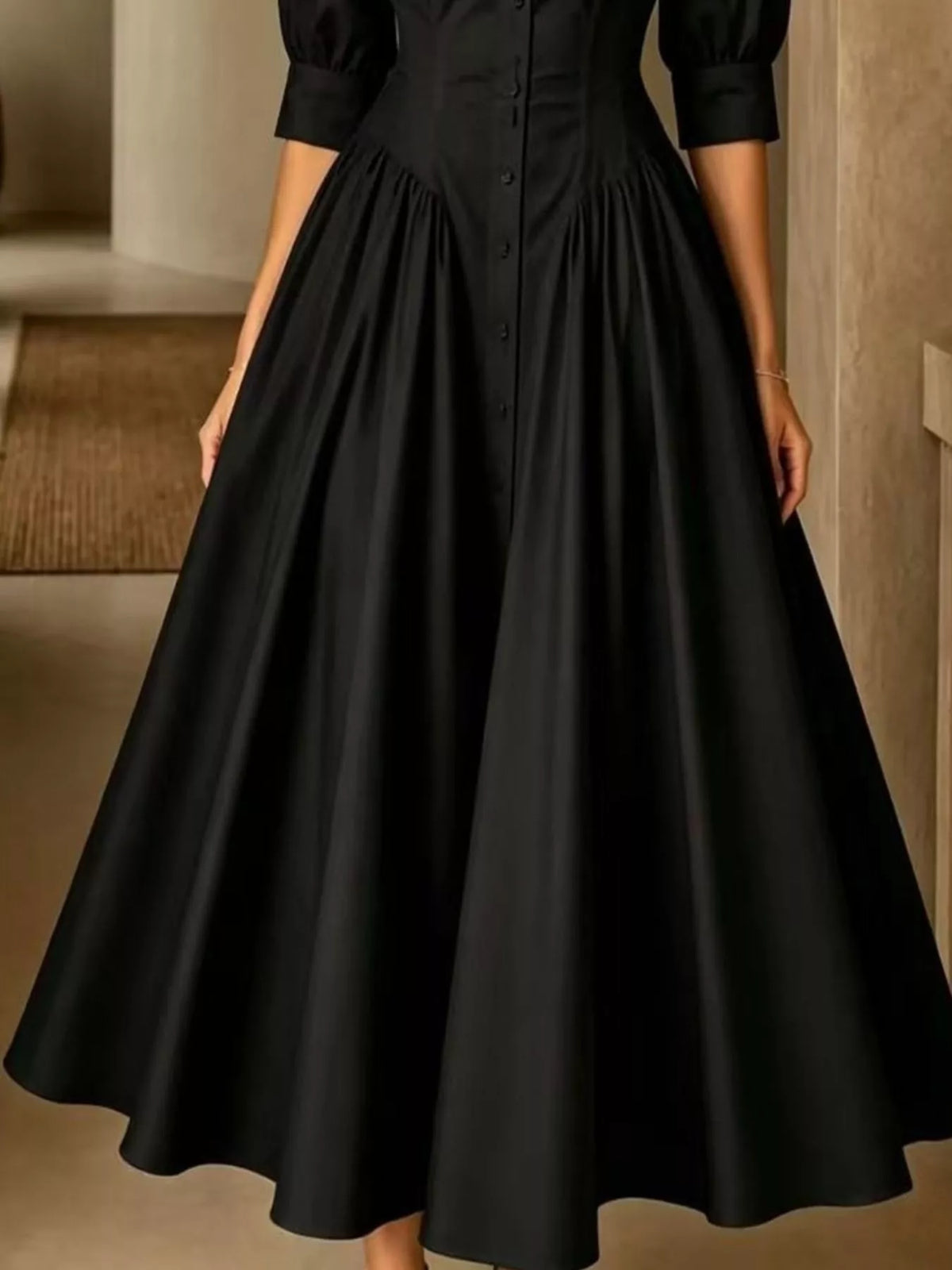 Black button-down shirt dress with cinched waist and full gathered skirt, 3/4 sleeves.