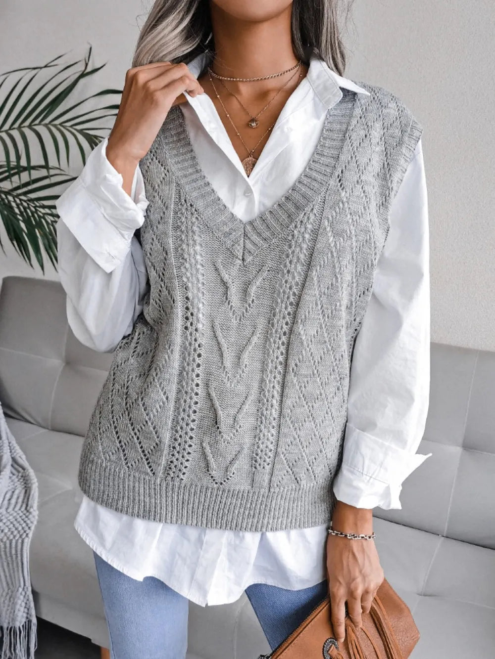Light gray openwork V-neck sweater vest, sleeveless knit with textured V and diamond motif.