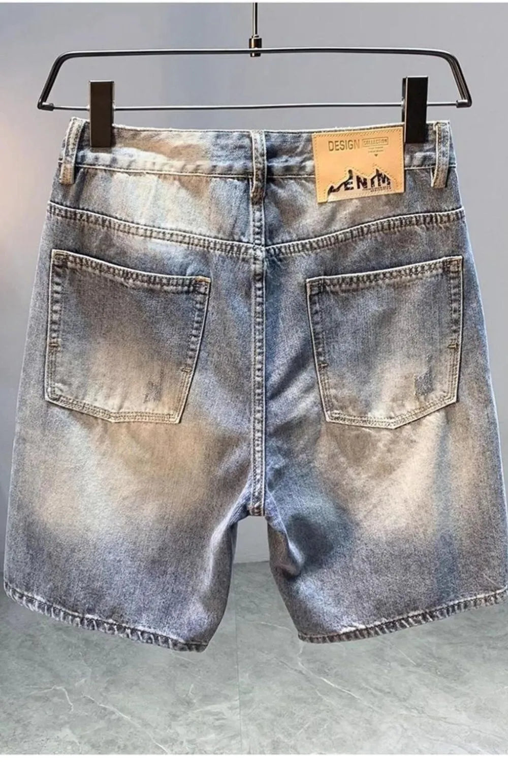 Men's distressed light blue denim shorts with front pockets and belt loops