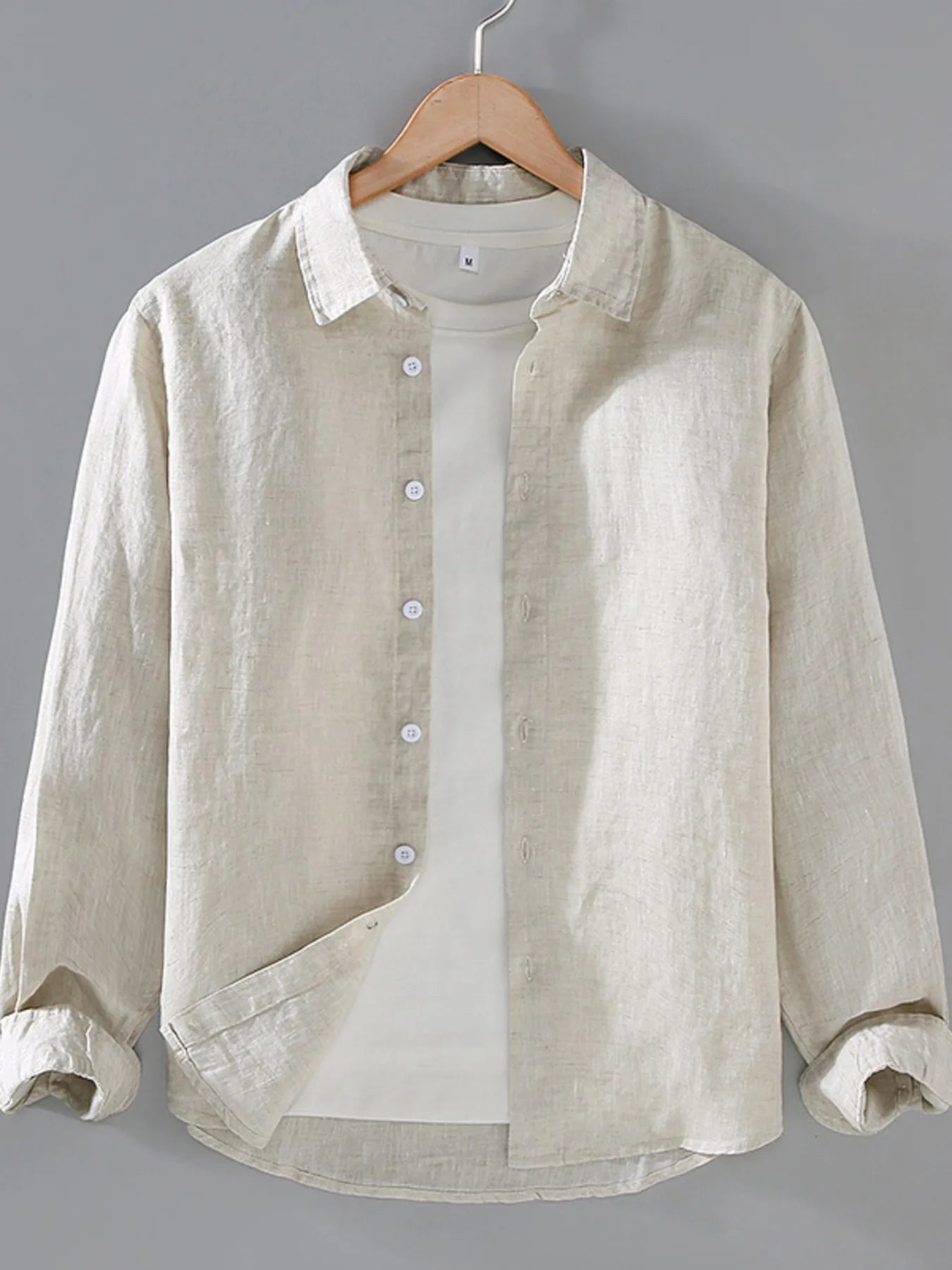 Cream button-up long sleeve shirt with front buttons and collared neckline